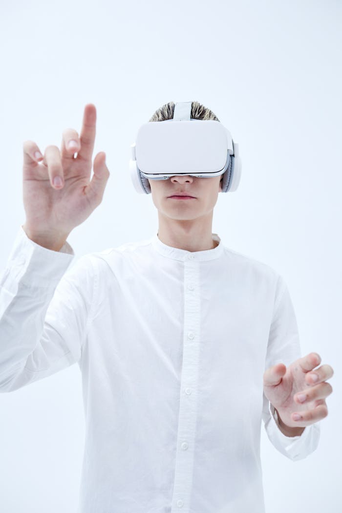Person using VR headset with futuristic white background, exploring virtual reality technology.